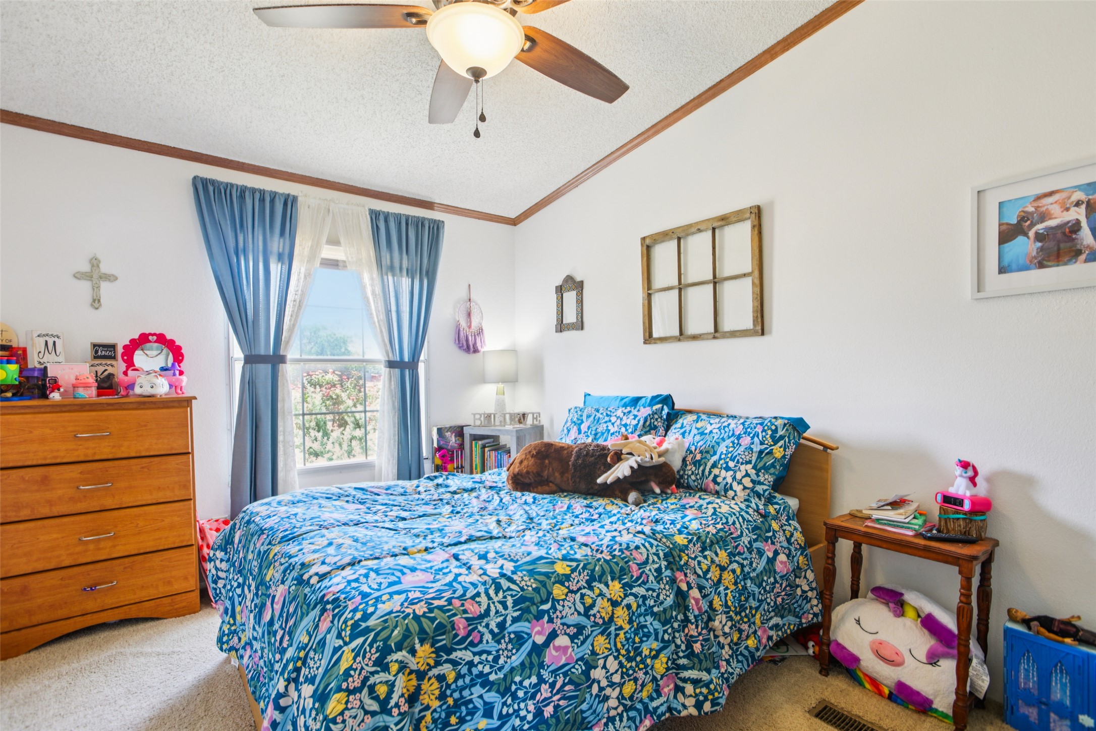 372 Hofferek Road Rosanky, TX 78953 - Photo 24 of 40 Carpeted bedroom featuring a textured ceiling, crown molding, and ceiling fan