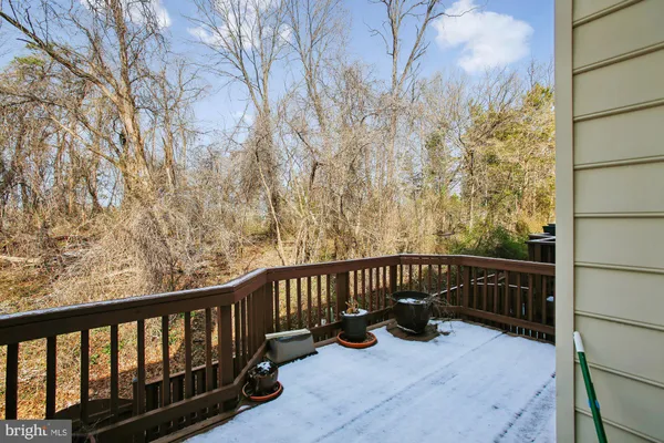 a view of a balcony with chairs and wooden fence