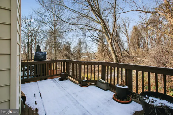 a view of balcony with wooden floor and fence