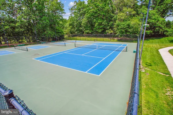 a view of a park that has sign board large trees