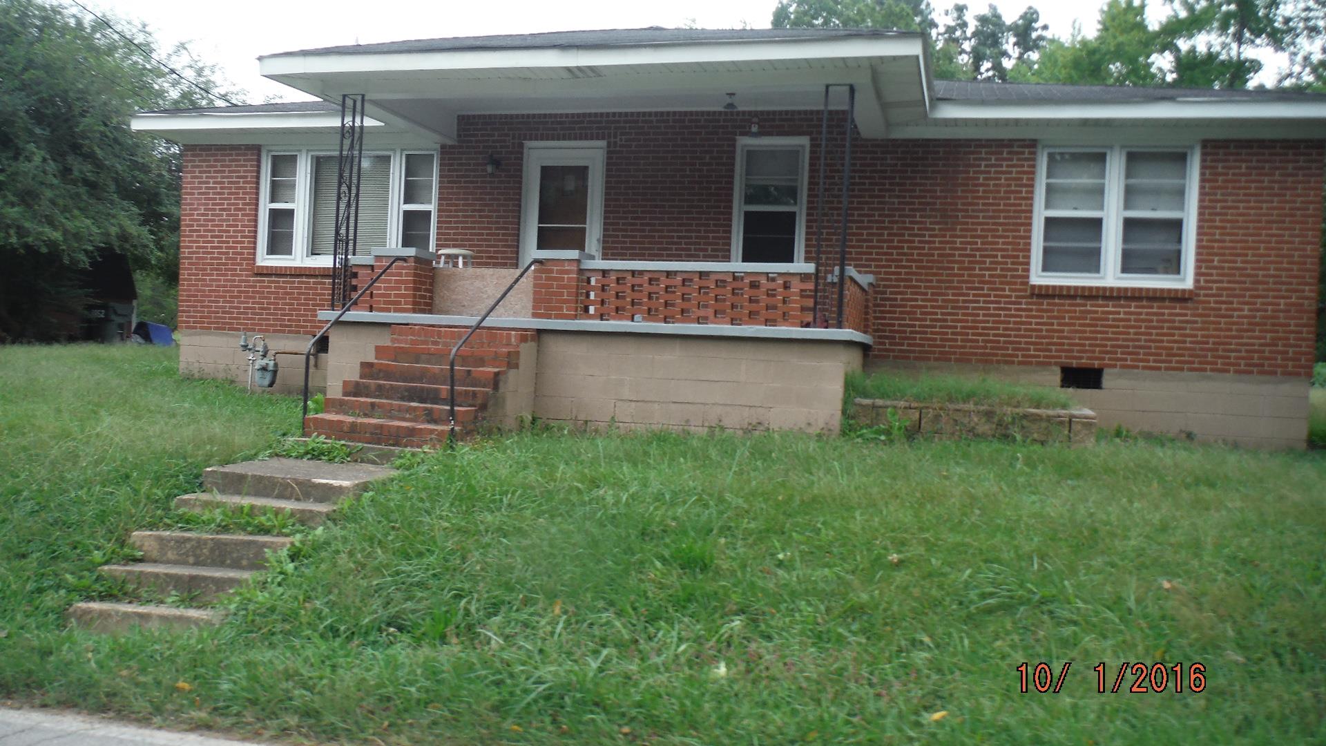8852 Pinewood Road Lyles, TN 37098 - Photo 1 of 14 a front view of house with yard and outdoor seating