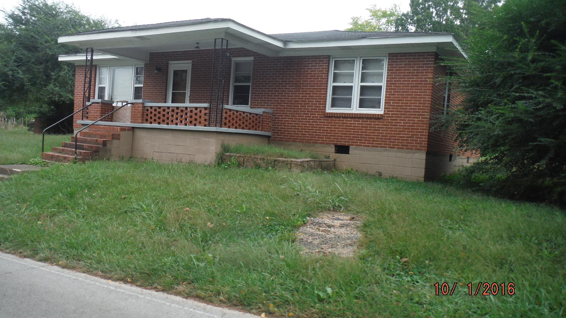 8852 Pinewood Road Lyles, TN 37098 - Photo 2 of 14 a view of an house with backyard space and garden