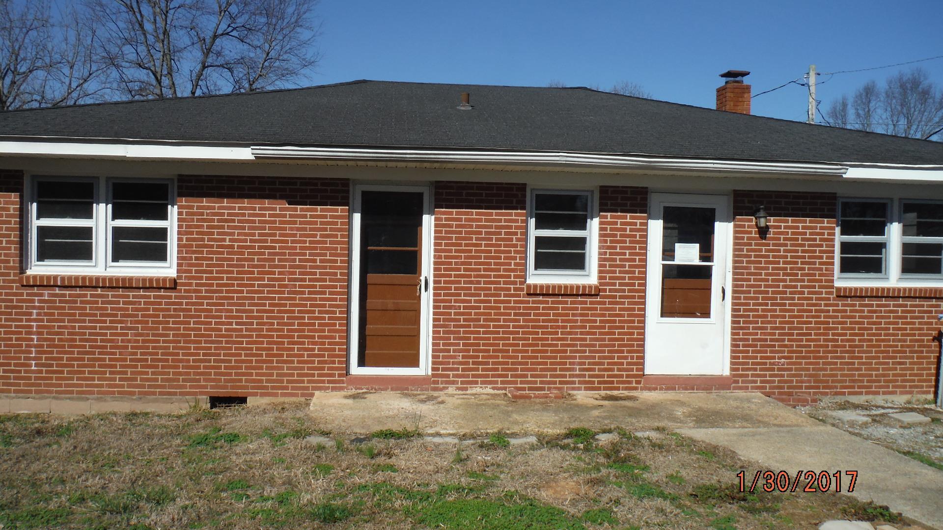 8852 Pinewood Road Lyles, TN 37098 - Photo 5 of 14 a front view of a house with a yard