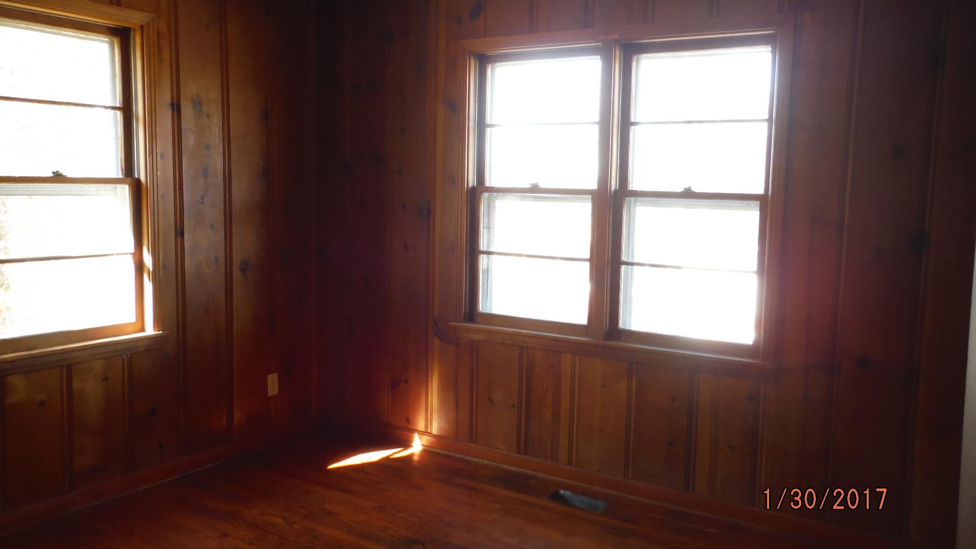 8852 Pinewood Road Lyles, TN 37098 - Photo 9 of 14 a view of an empty room with wooden floor and a window
