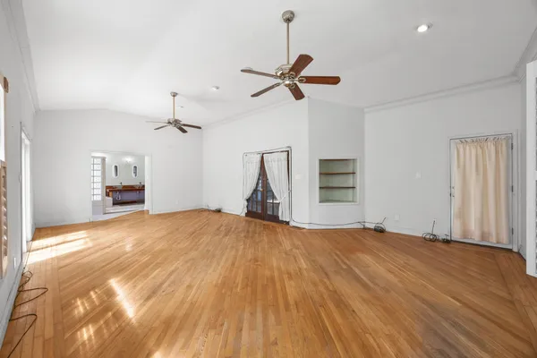 a view of empty room with a fireplace and wooden floor