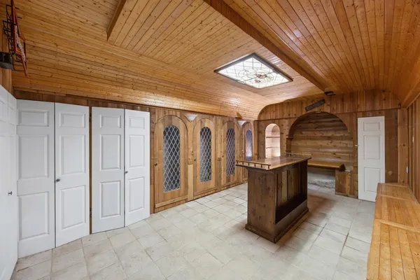 a view of an empty room with kitchen