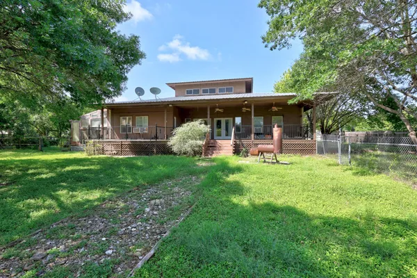 a view of a house with a backyard porch and sitting area