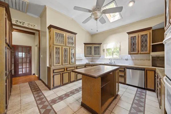 a kitchen with stainless steel appliances granite countertop a sink and a stove