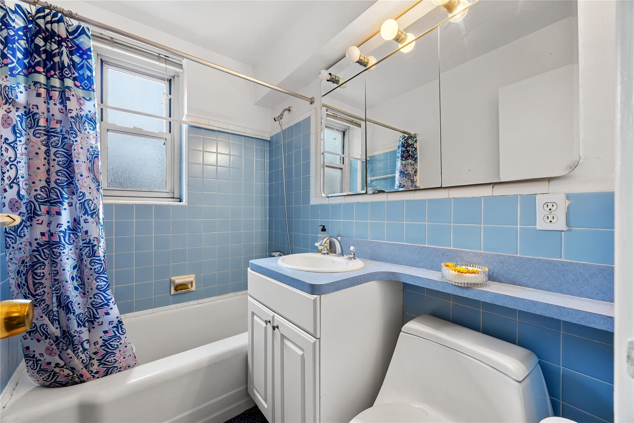 210-15 23rd Avenue, Unit 3B Queens, NY 11360 - Photo 11 of 18 a bathroom with a sink and a bathtub