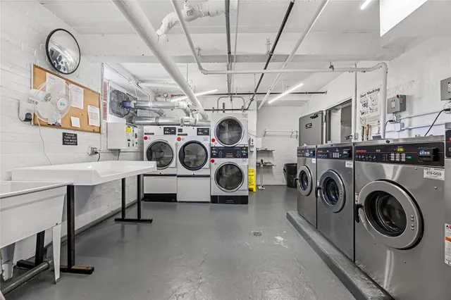 a view of a storage & utility room with racks a sink
