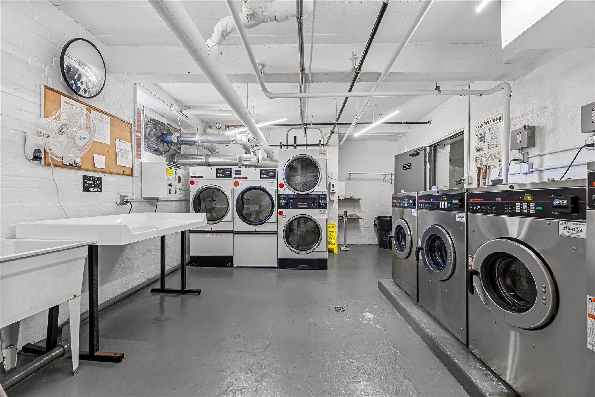 210-15 23rd Avenue, Unit 3B Queens, NY 11360 - Photo 15 of 18 a view of a storage & utility room with racks a sink