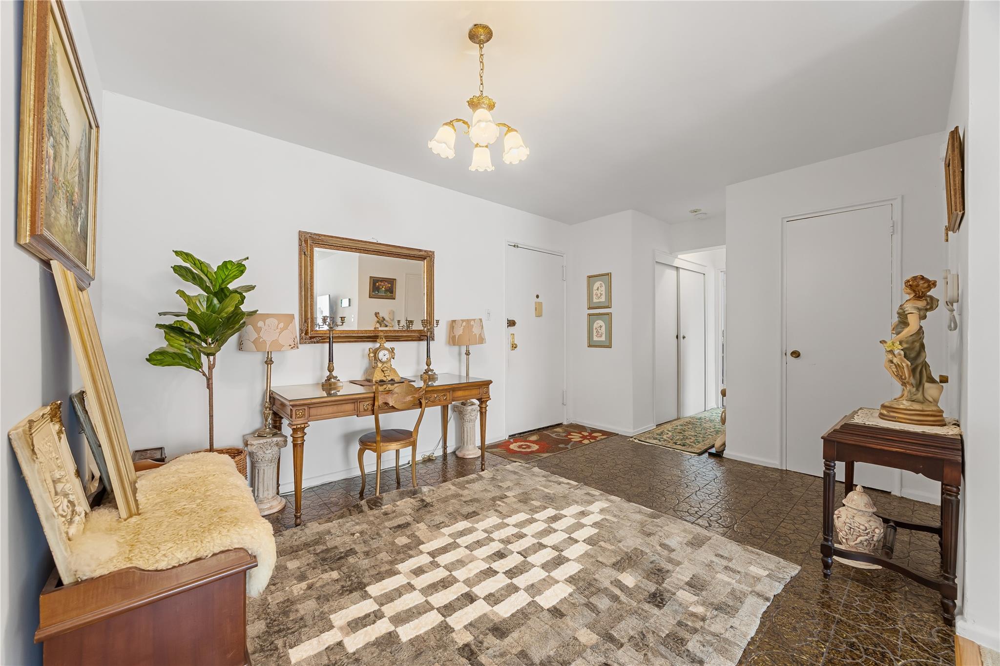 210-15 23rd Avenue, Unit 3B Queens, NY 11360 - Photo 3 of 18 a living room with furniture a piano and a chandelier
