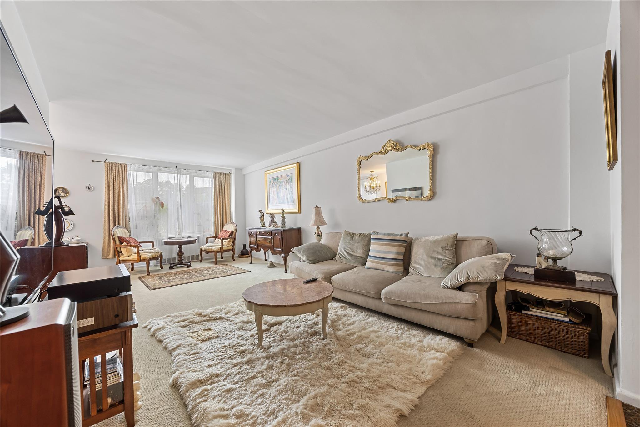 210-15 23rd Avenue, Unit 3B Queens, NY 11360 - Photo 4 of 18 a living room with furniture and wooden floor