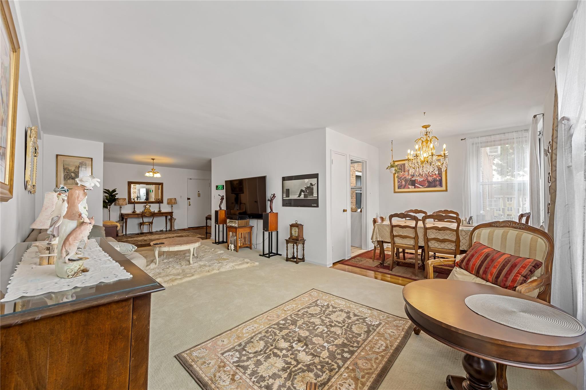 210-15 23rd Avenue, Unit 3B Queens, NY 11360 - Photo 5 of 18 a living room with furniture and a flat screen tv