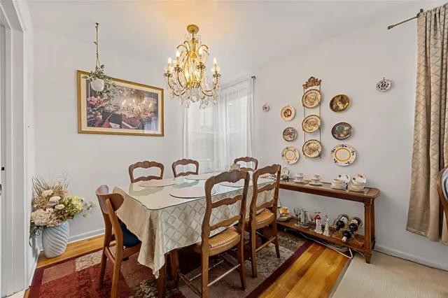 a view of a dining room with furniture and chandelier