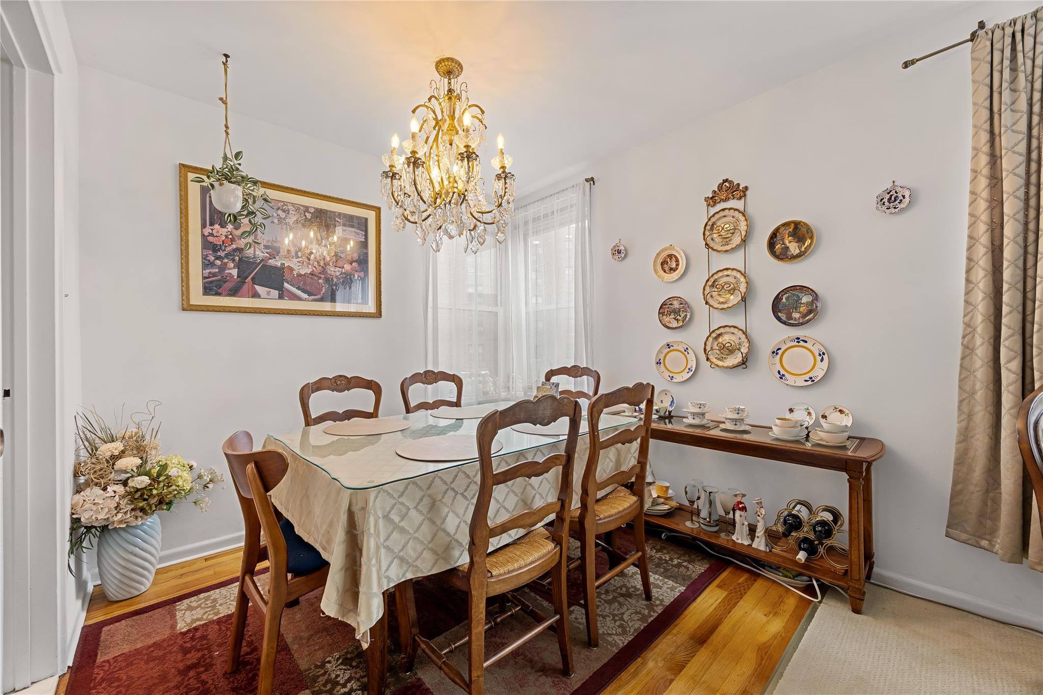 210-15 23rd Avenue, Unit 3B Queens, NY 11360 - Photo 7 of 18 a view of a dining room with furniture and chandelier
