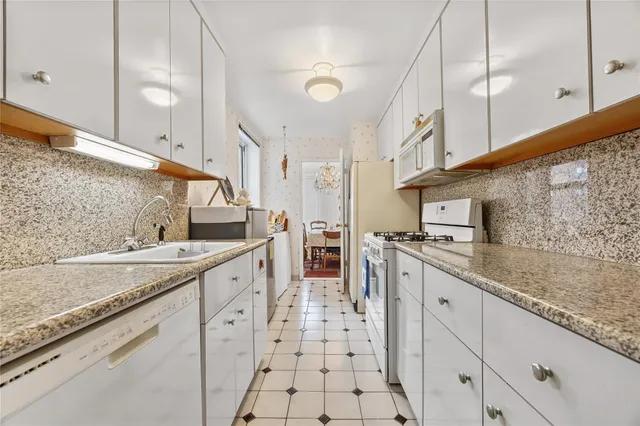 a large kitchen with a sink and cabinets
