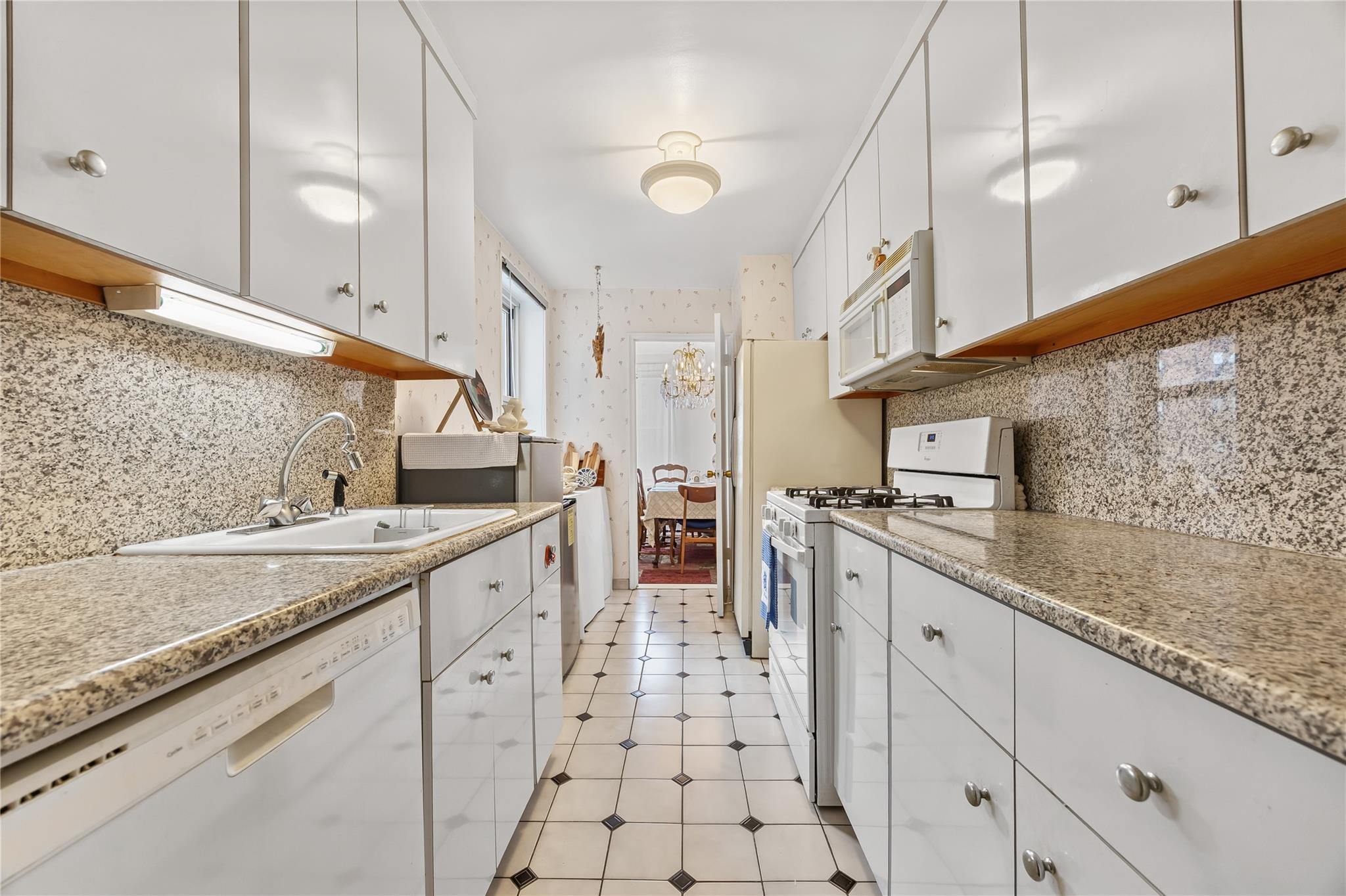 210-15 23rd Avenue, Unit 3B Queens, NY 11360 - Photo 8 of 18 a large kitchen with a sink and cabinets