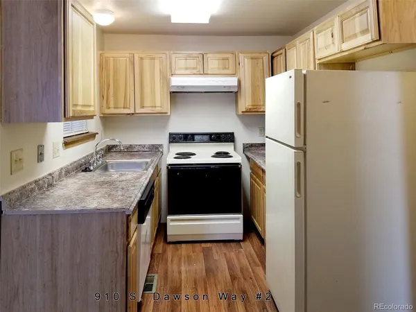 a kitchen with a refrigerator sink and stove