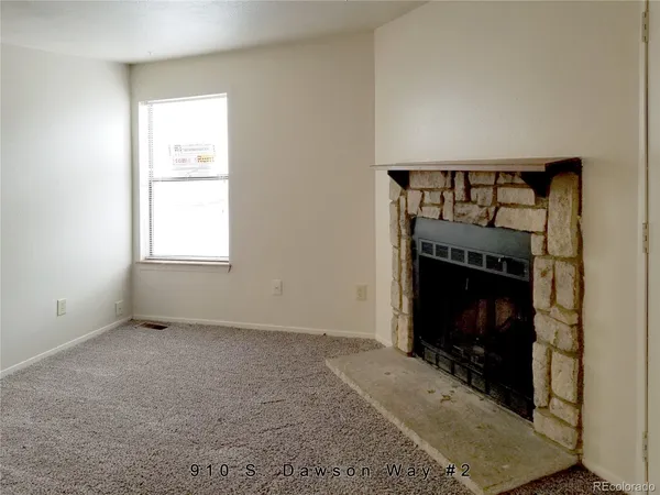 a living room with a fireplace and a window