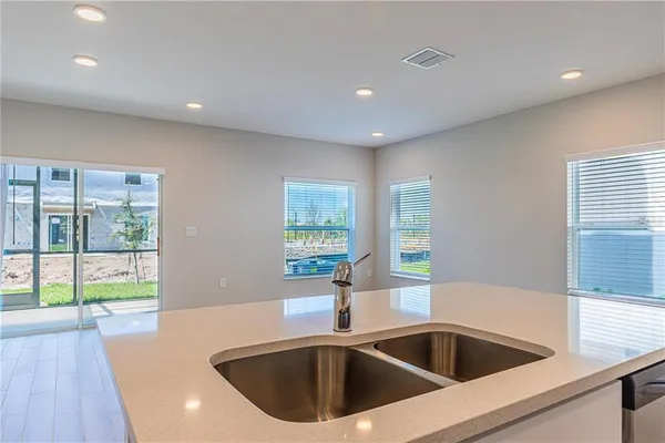 a bathroom with a sink a toilet a mirror a vanity a bathtub and shower