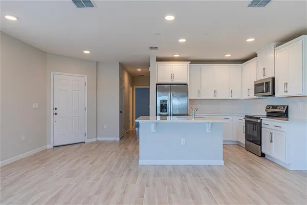 a bathroom with a double vanity sink mirror and toilet