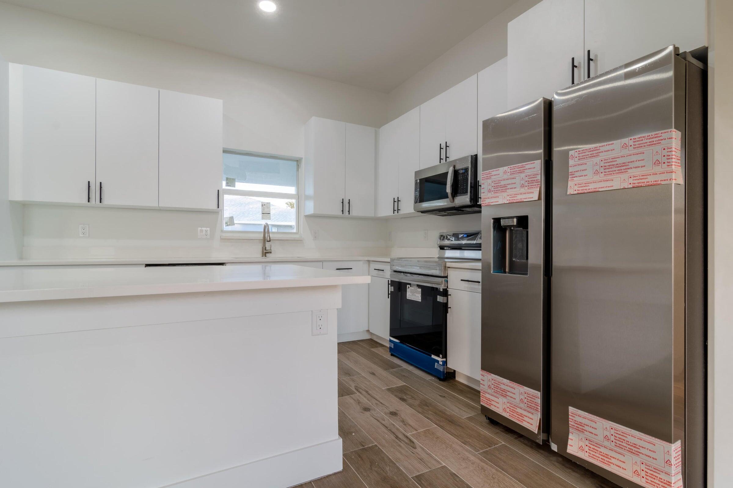 10625 Ayear Road Port Charlotte, FL 33981 - Photo 15 of 33 a kitchen with a refrigerator and a stove top oven