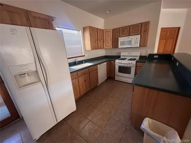 a kitchen with stainless steel appliances a refrigerator a stove a sink and a refrigerator