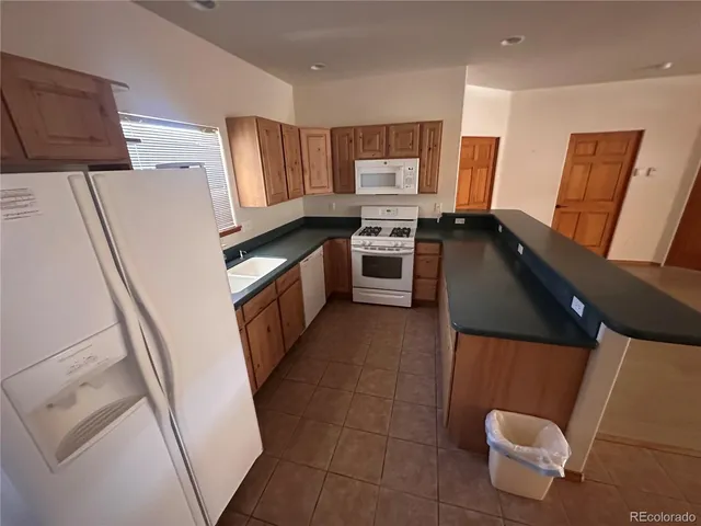 a kitchen with stainless steel appliances a refrigerator stove and sink