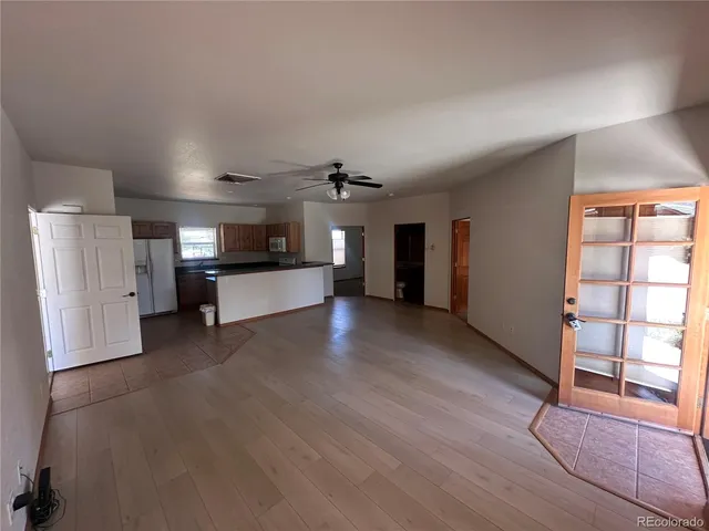 a view of a kitchen with a sink and a refrigerator