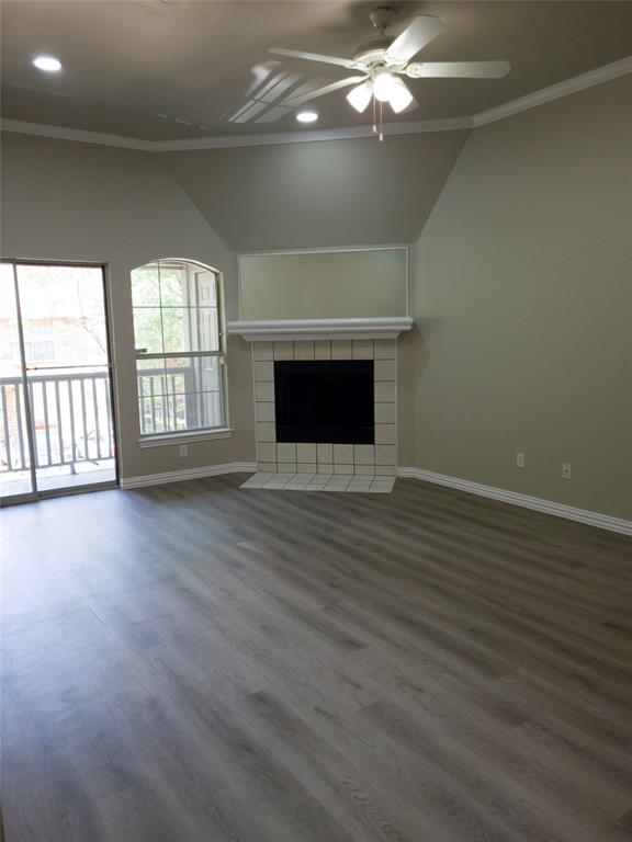 1501 Cedar Elm Drive, Unit 201 Euless, TX 76039 - Photo 11 of 23 en empty room with wooden floor fan and window