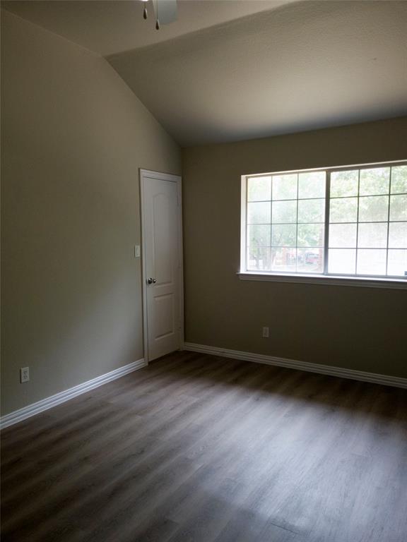 1501 Cedar Elm Drive, Unit 201 Euless, TX 76039 - Photo 16 of 23 an empty room with wooden floor and windows