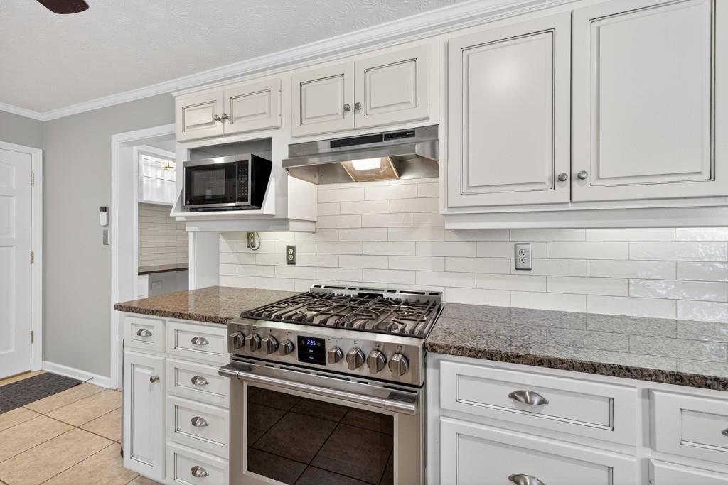 82 Cedar Bluff Winder, GA 30680 - Photo 25 of 47 a kitchen with white cabinets and appliances