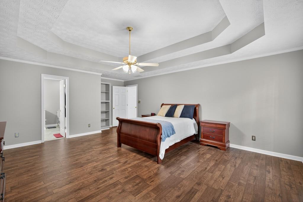 82 Cedar Bluff Winder, GA 30680 - Photo 31 of 47 a spacious bedroom with a bed and wooden floor