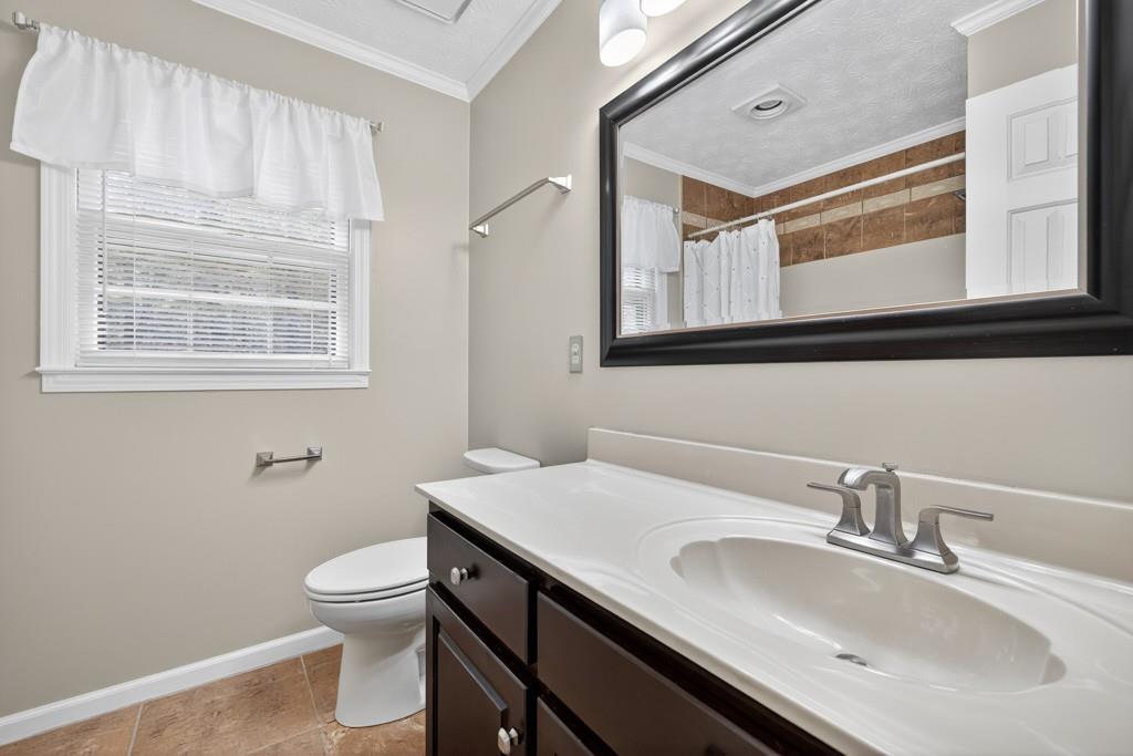 82 Cedar Bluff Winder, GA 30680 - Photo 41 of 47 a bathroom with a sink a toilet and a mirror