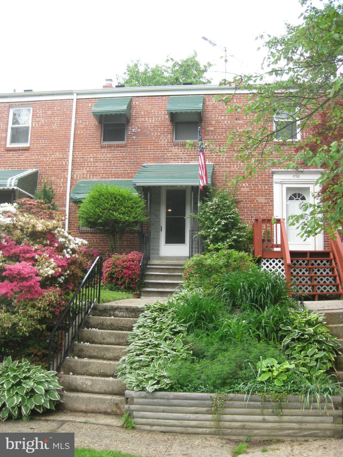 1728 Pin Oak Road Baltimore, MD 21234 - Photo 1 of 19 a front view of a house with a yard and potted plants