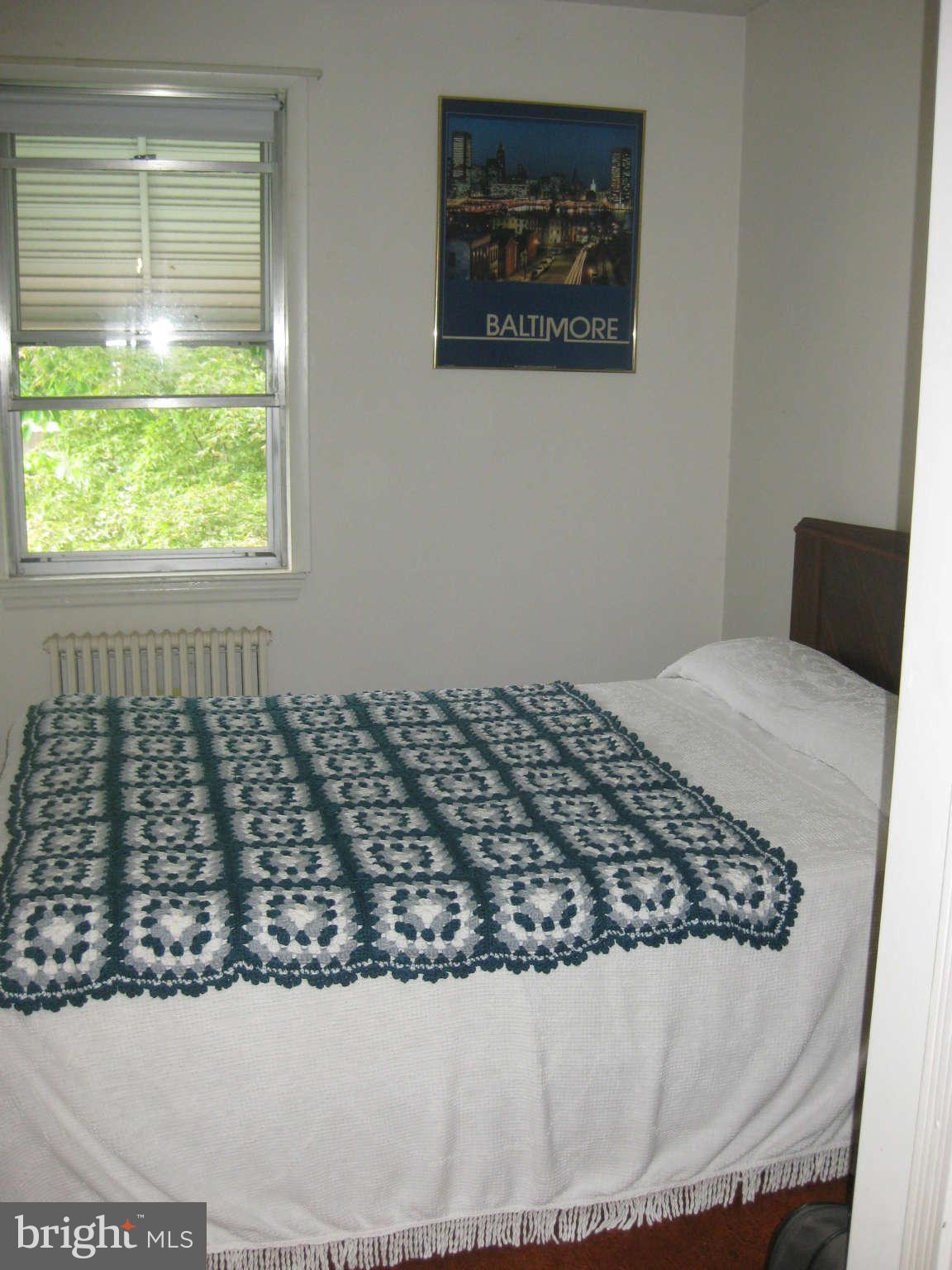1728 Pin Oak Road Baltimore, MD 21234 - Photo 12 of 19 a bed sitting in a bedroom next to a window