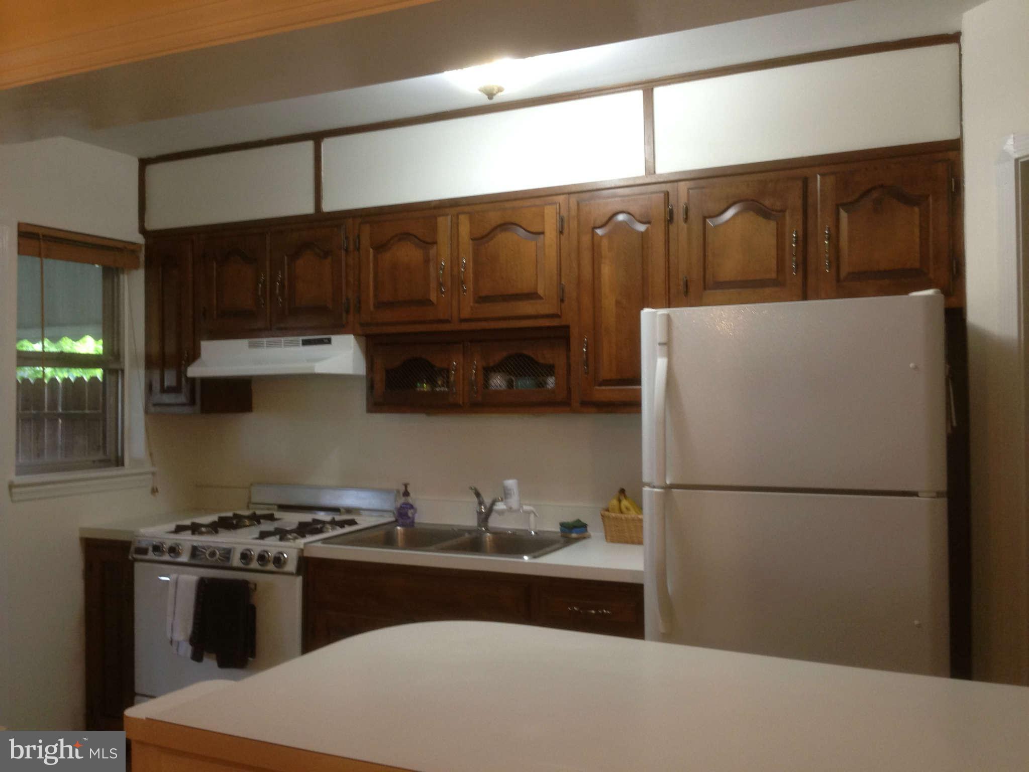 1728 Pin Oak Road Baltimore, MD 21234 - Photo 8 of 19 a kitchen with a refrigerator and a sink