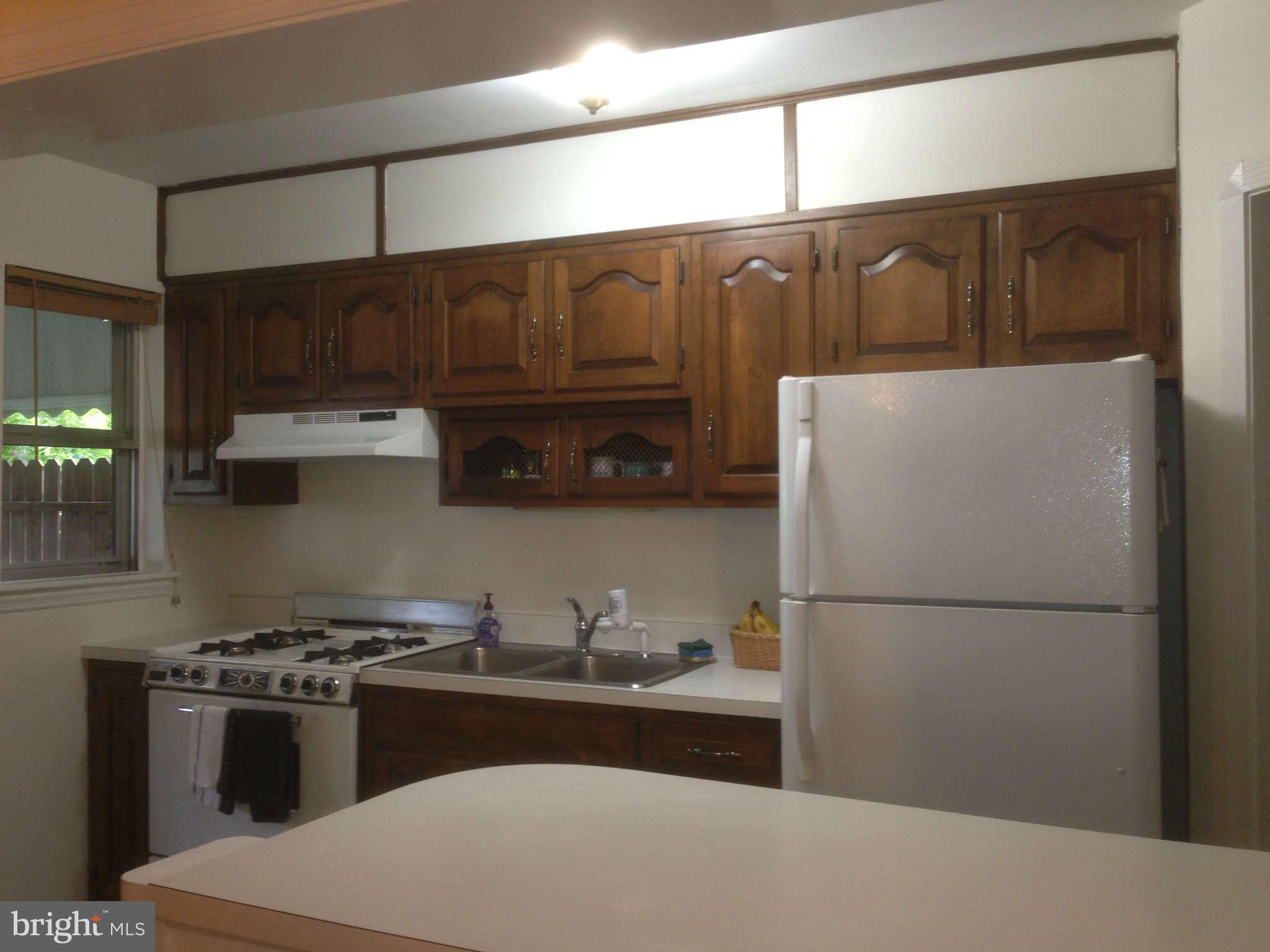 1728 Pin Oak Road Baltimore, MD 21234 - Photo 9 of 19 a kitchen with a refrigerator and a sink