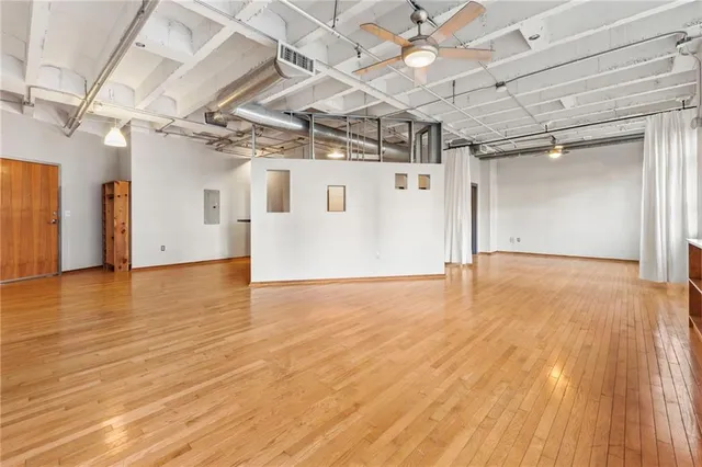 a view of a room with wooden floors