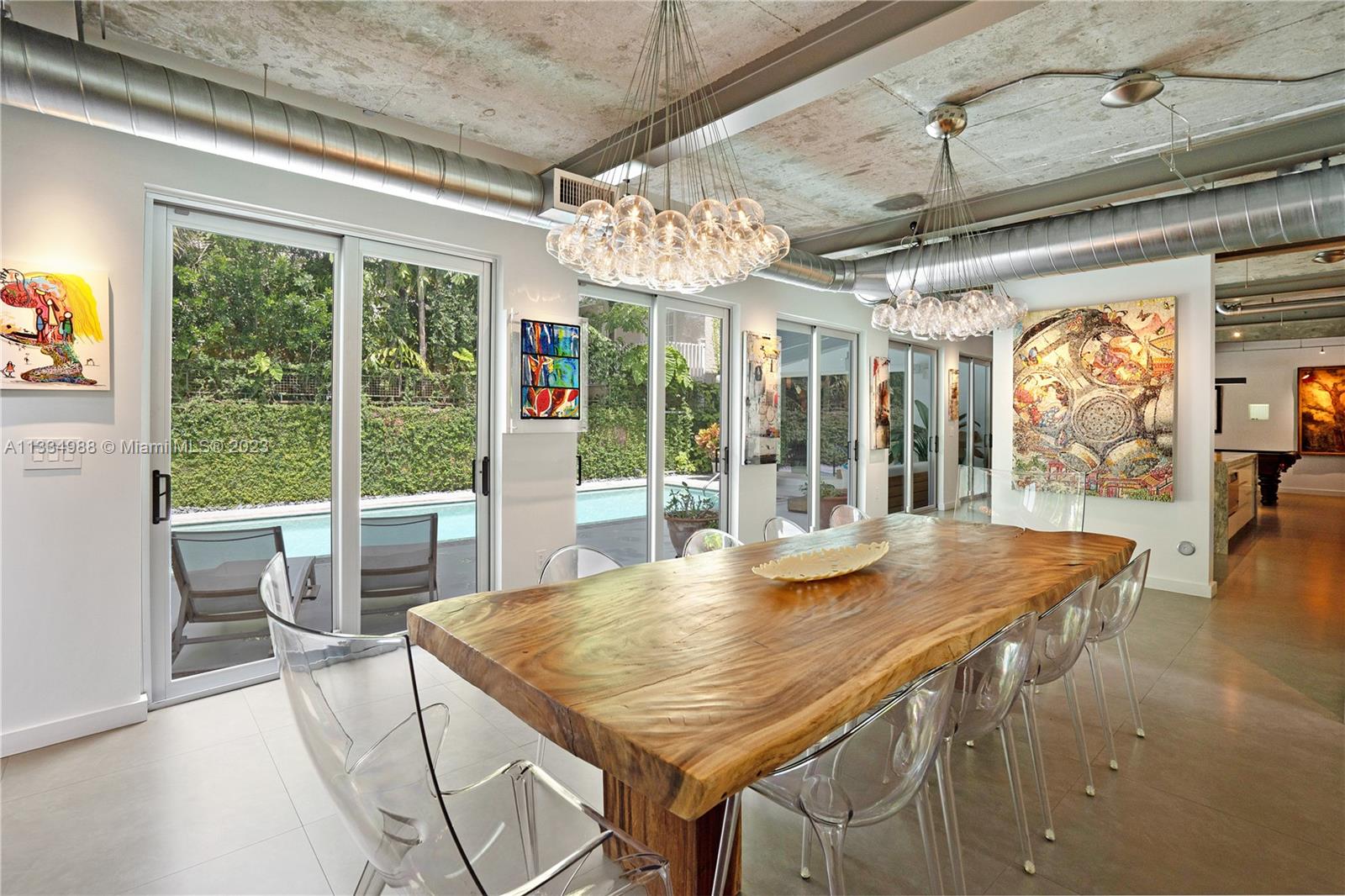 a view of a dining room with furniture large windows and wooden floor