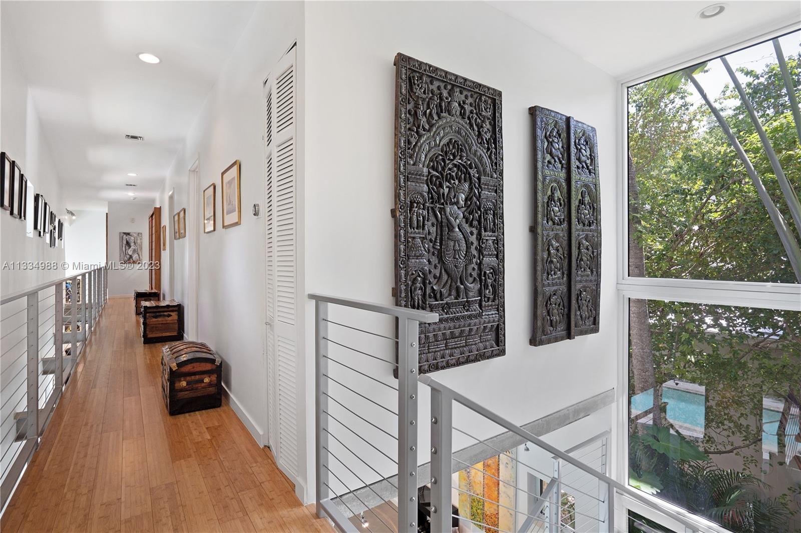 4091 Park Avenue Miami, FL 33133 - Photo 12 of 35 a view of a hallway with wooden floor and staircase