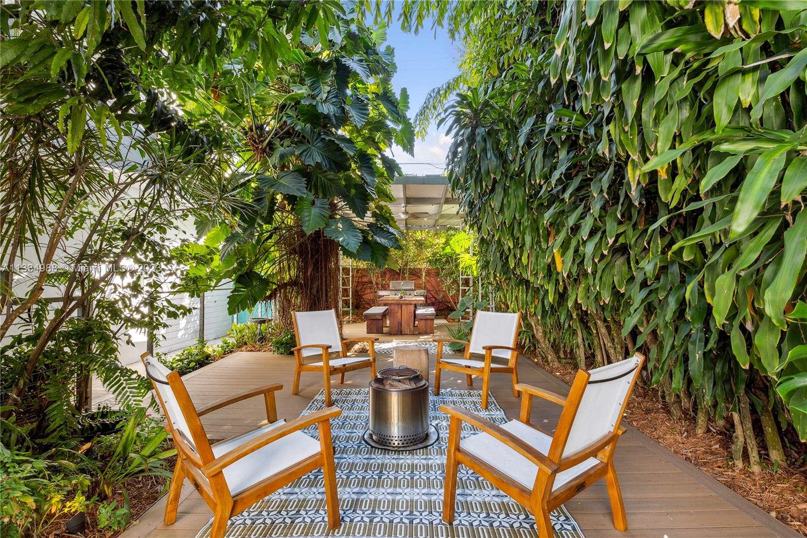 4091 Park Avenue Miami, FL 33133 - Photo 22 of 35 a view of a patio with table and chairs and potted plants