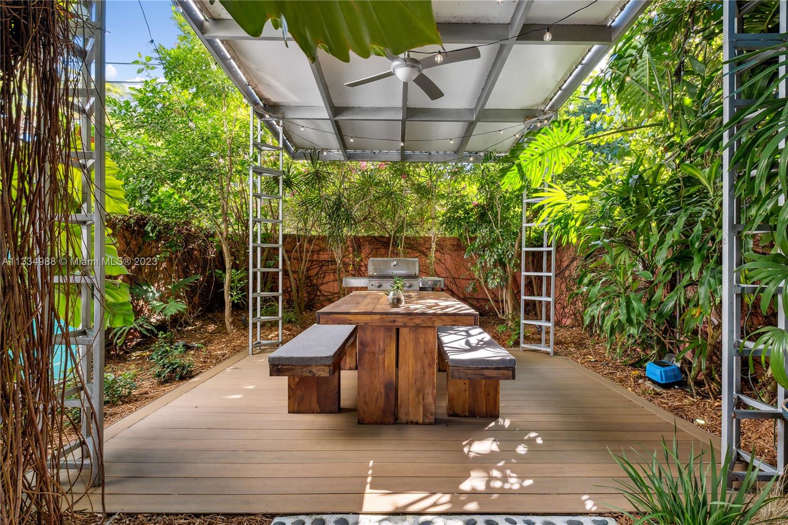 4091 Park Avenue Miami, FL 33133 - Photo 23 of 35 a view of a patio with table and chairs potted plants with wooden floor