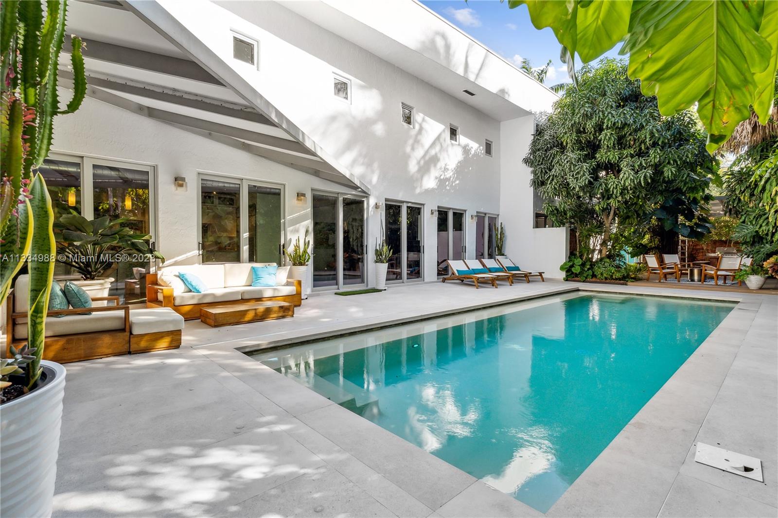 4091 Park Avenue Miami, FL 33133 - Photo 29 of 35 a view of a swimming pool with a patio
