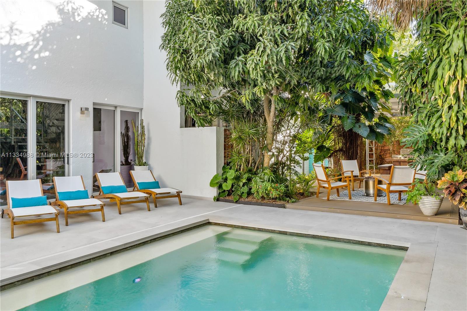 4091 Park Avenue Miami, FL 33133 - Photo 30 of 35 swimming pool view with tables and chairs