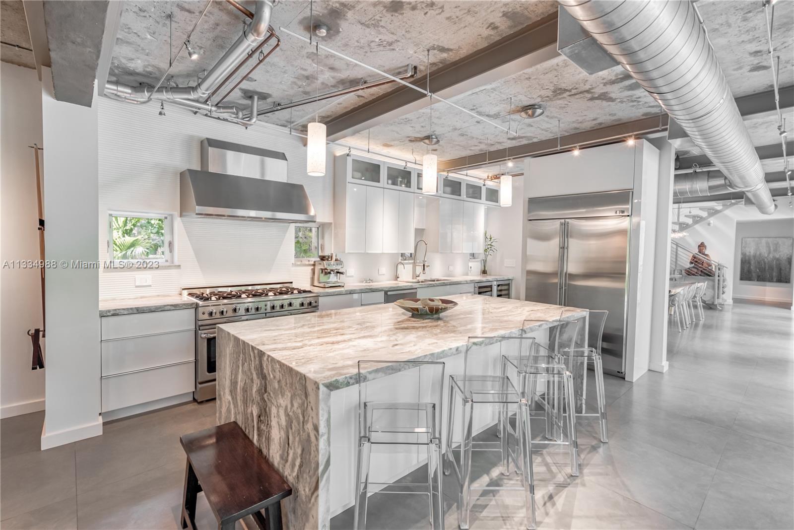 4091 Park Avenue Miami, FL 33133 - Photo 3 of 35 a kitchen with stainless steel appliances granite countertop a stove and a refrigerator