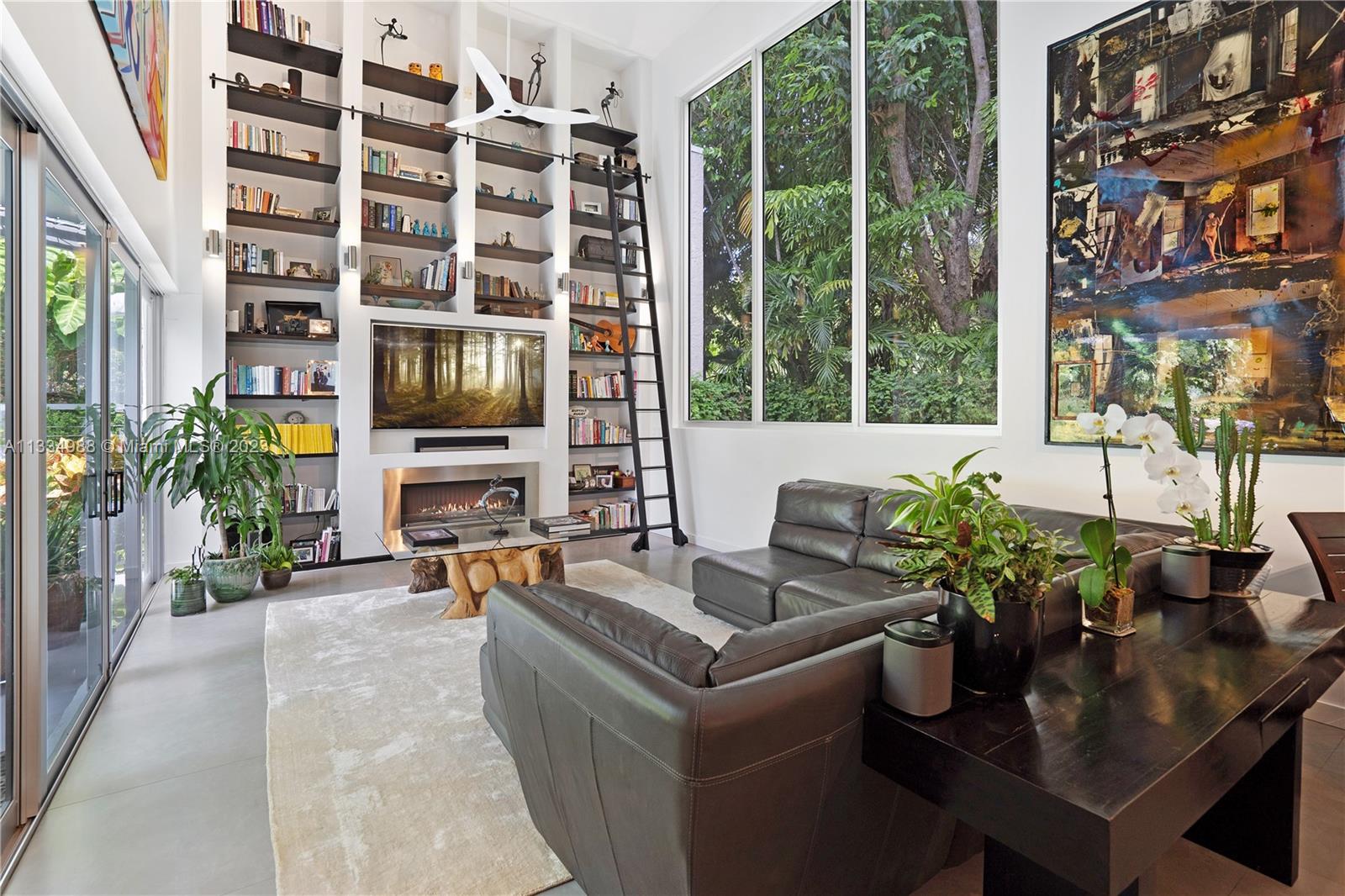 4091 Park Avenue Miami, FL 33133 - Photo 6 of 35 a living room with furniture a flat screen tv and a fireplace