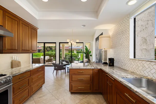 a view of a house with backyard sitting area and garden