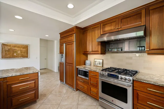 an aerial view of residential houses with outdoor space and parking